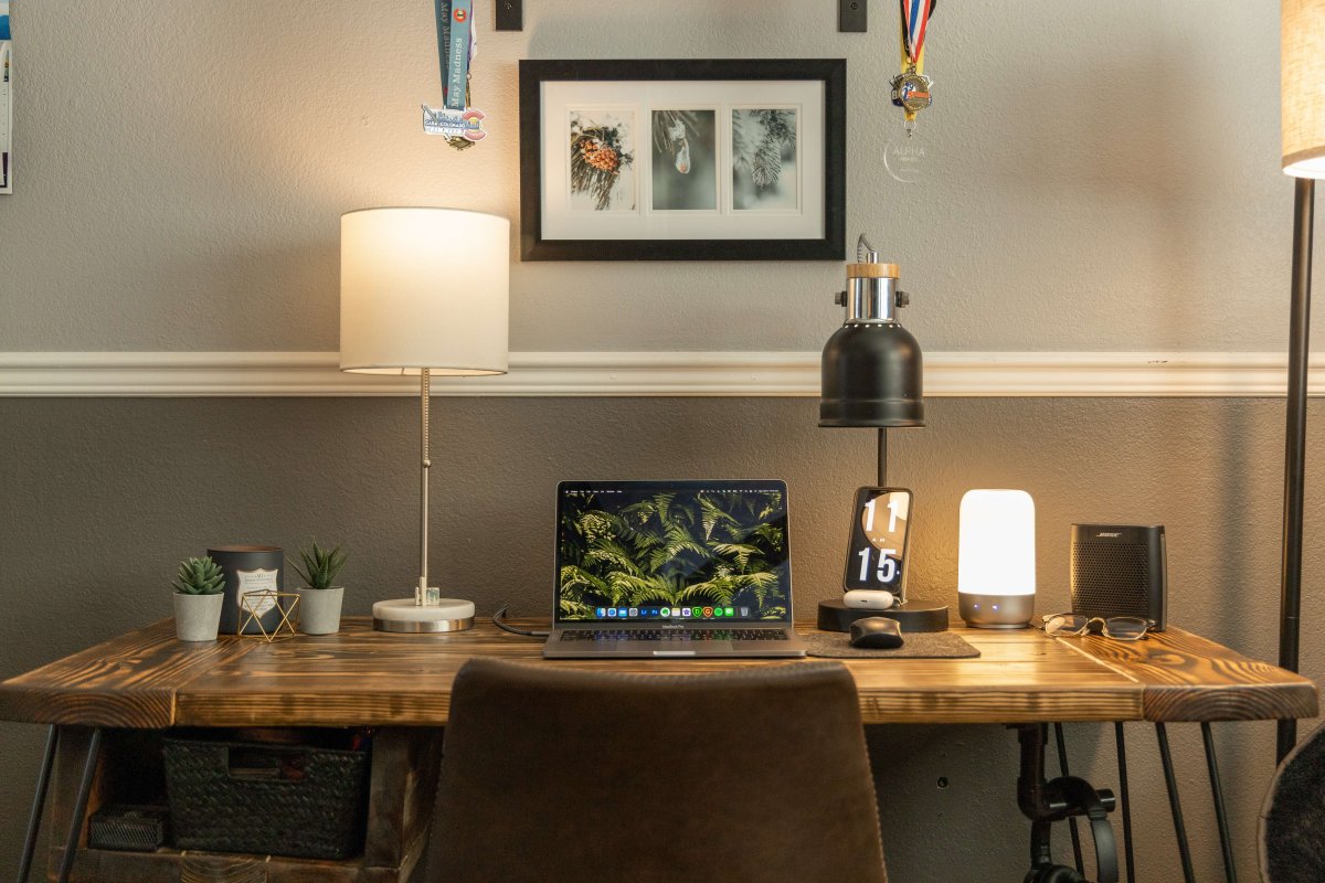 Small desk with many feature lights and a laptop.