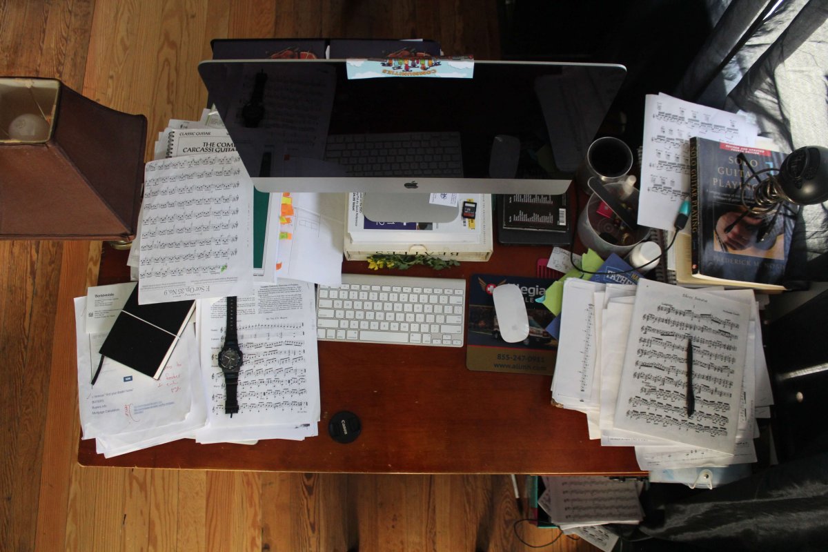 A very messy desk and work space.